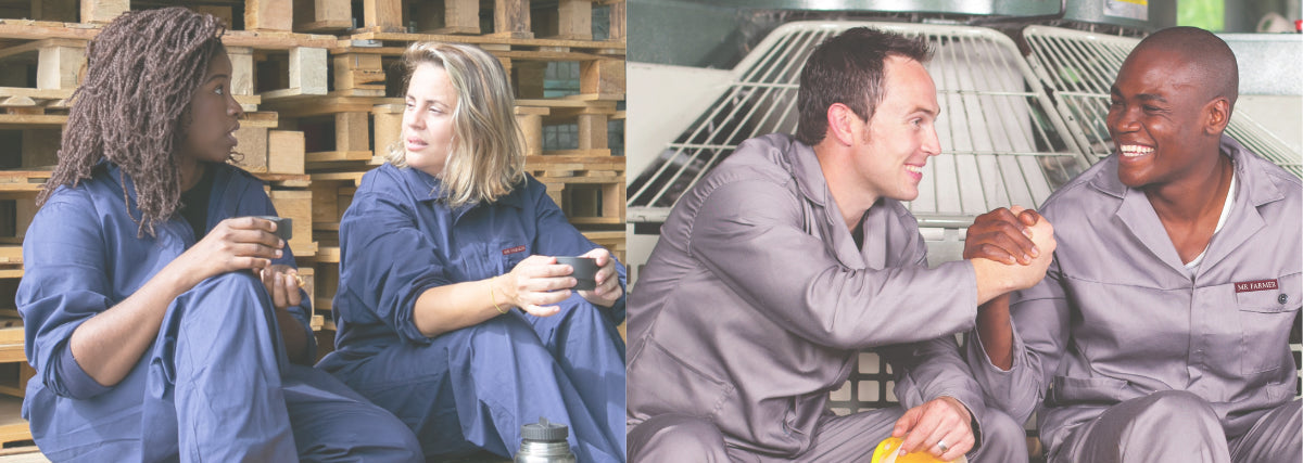 Men and women in overalls sitting in a work environment with hard hats