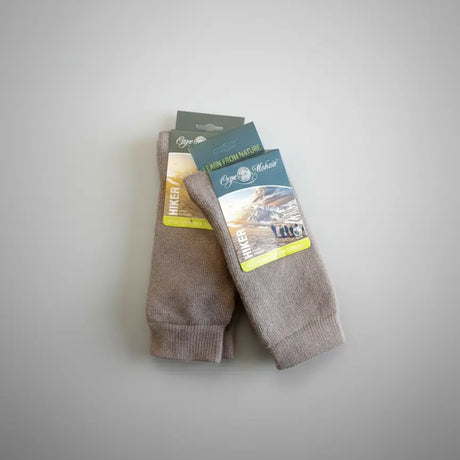 Pair of khaki socks with packaging on a light gray background